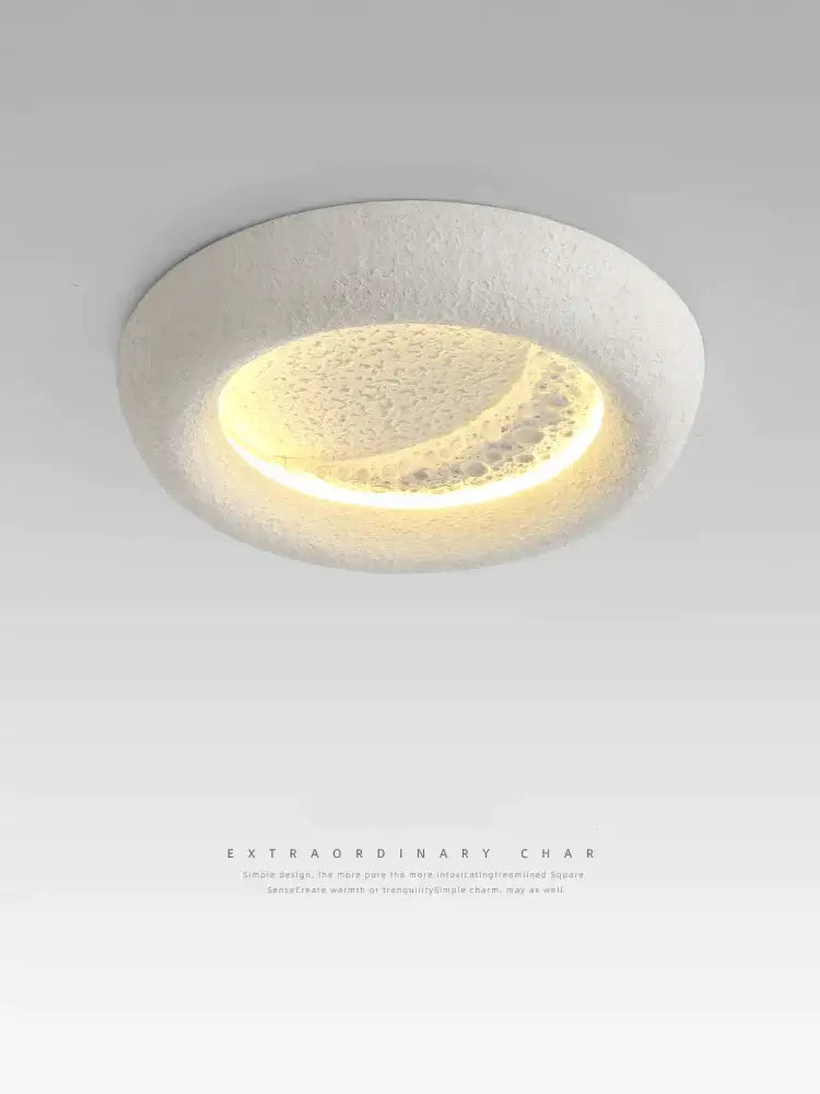 A modern cream breeze moon ceiling lamp with a textured white ring and warm yellow crescent light for bedroom decorbites