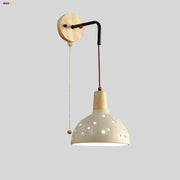 Modern cream ceramic and wood wall light with circular cutouts and pull chain switch for bedroom decorbites cement wood wall