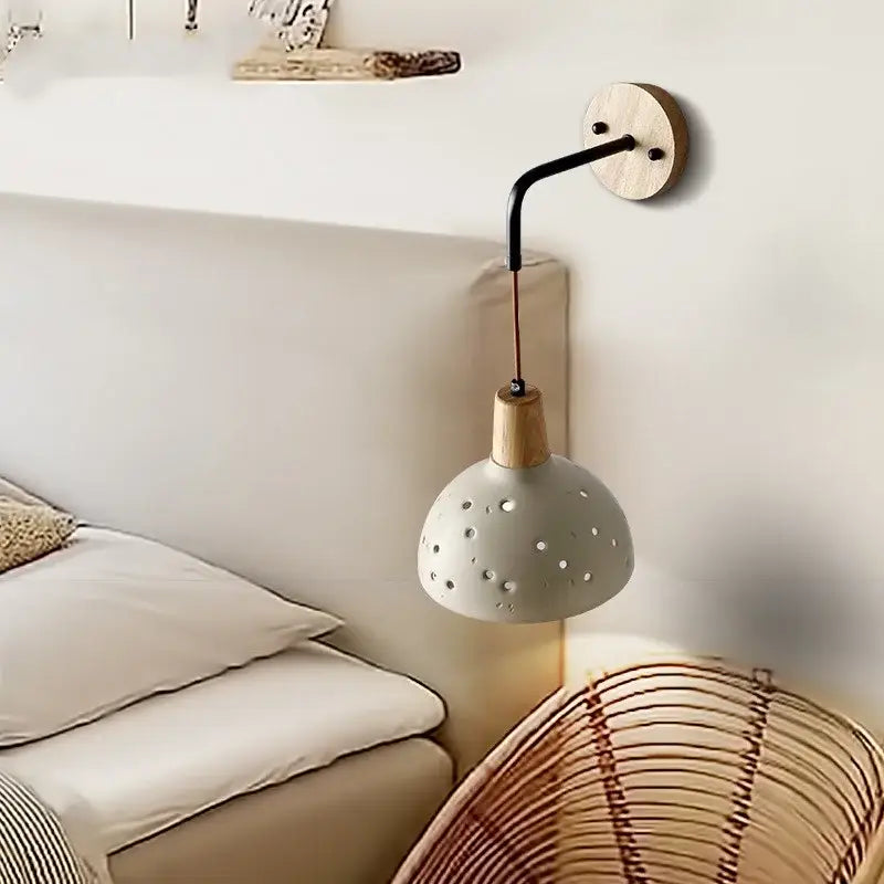 Modern cream ceramic and wood wall light with matte gray perforated shade and black metal arm for decorbites cement wood wall decor
