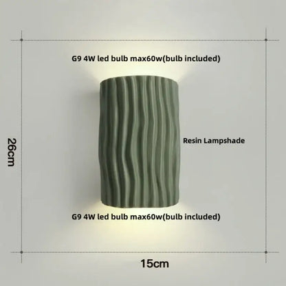 Modern cream ceramic ridged led wall lamp with a cylindrical dark green resin lampshade featuring vertical wavy ridges