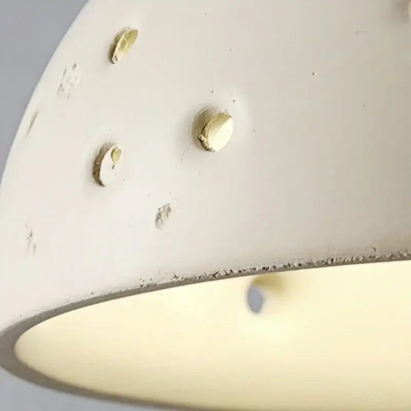 Modern cream ceramic wall lamp with off-white ceramic lampshade and brass screw fasteners featuring pull chain switch