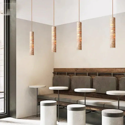 Four cream concrete pendant lights with warm wooden shades provide a modern light source for dining lighting area