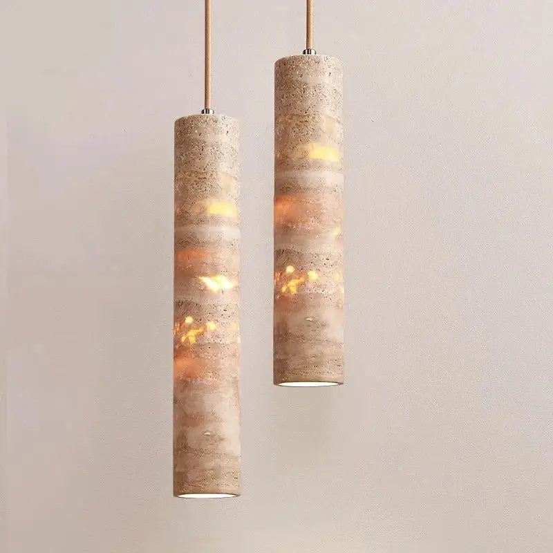 Modern cream concrete pendant light with warm amber glow as a stylish light source for dining room lighting area