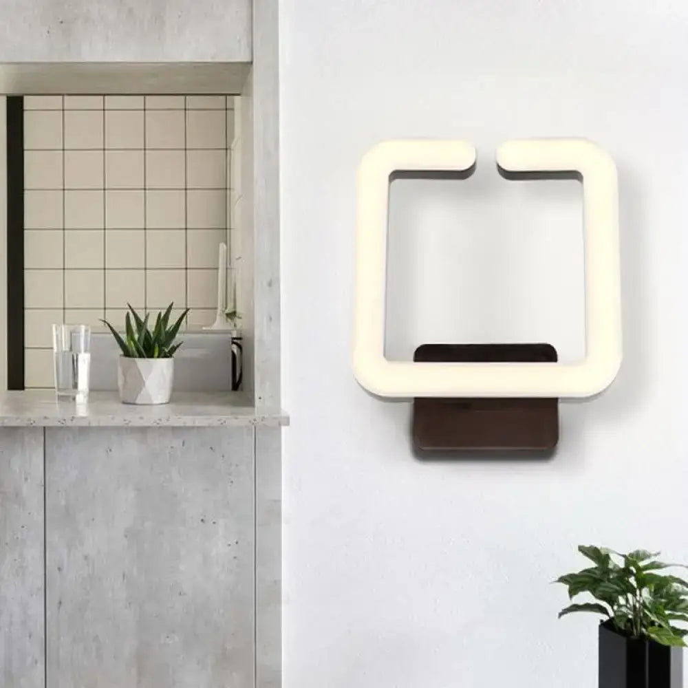 Modern cream rectangular wall sconce with dark brown base direct wired electric providing warm white natural light