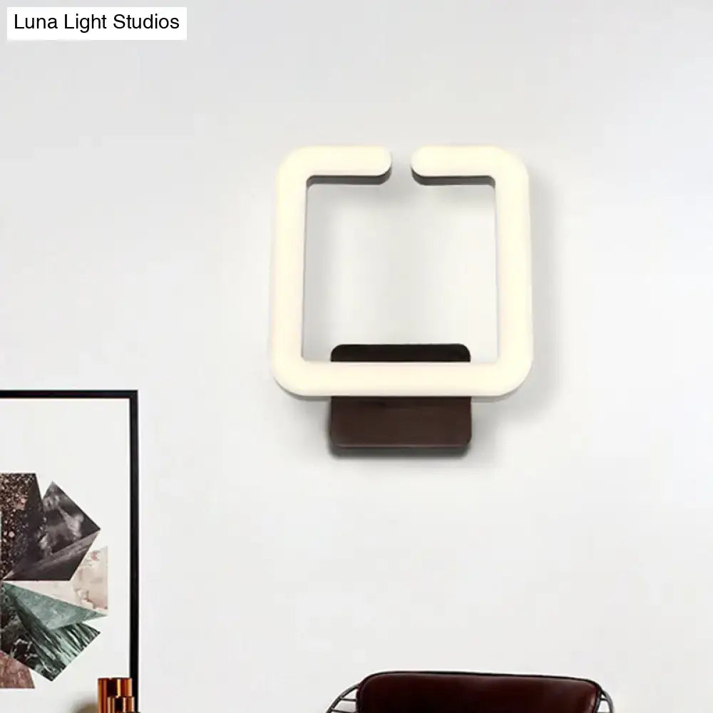 Modern cream square wall sconce with dark brown base direct wired electric providing warm white natural light for bedroom