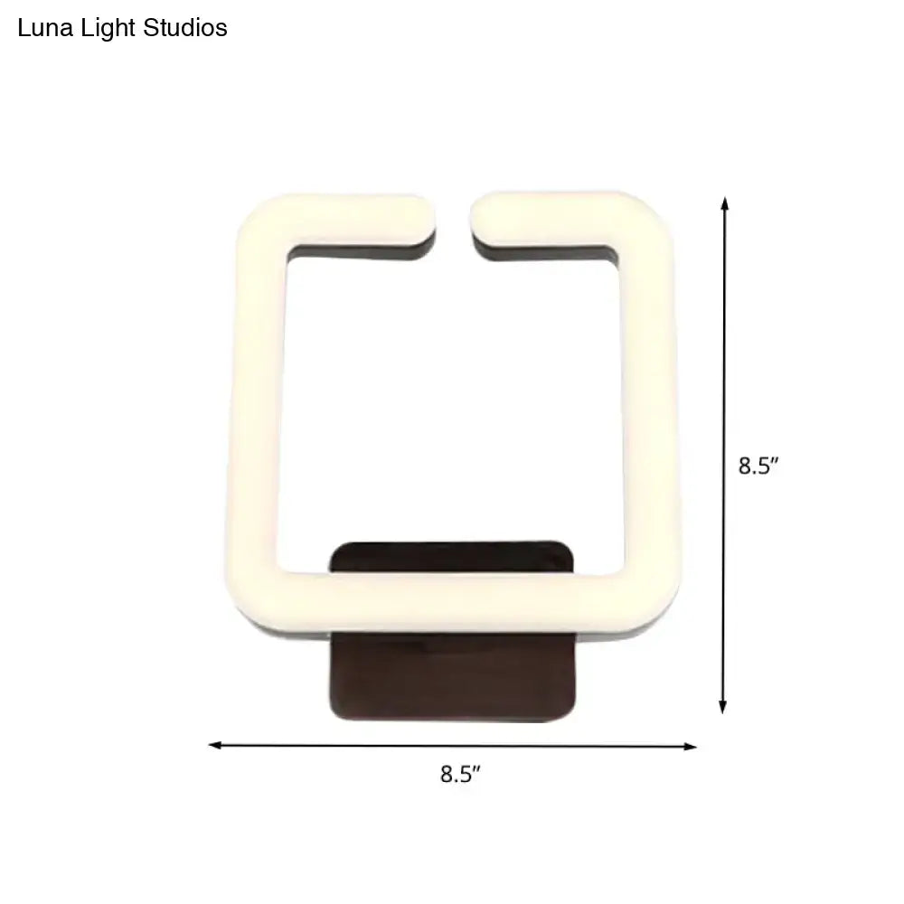 Modern cream square direct wired electric wall sconce with dark brown base providing warm white natural light