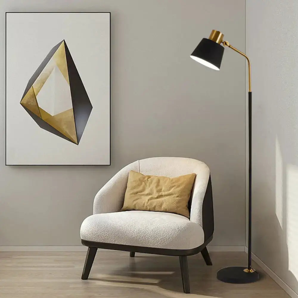 Cream-colored upholstered armchair with dark wood legs and mustard-yellow cushion beside DecorBites™ black floor lamp