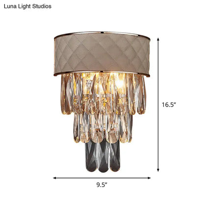 Modern cream wall lamp with quilted taupe fabric shade and crystal prism shade featuring clear and dark gray crystals