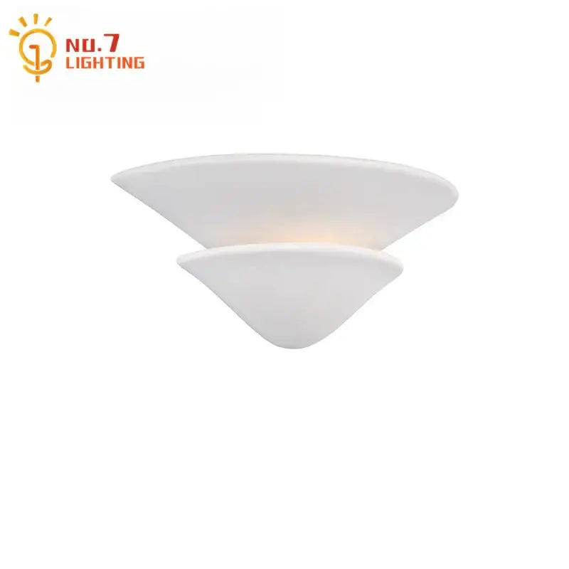 White two-tiered glass wall lamp with cream wind umbrella design in a modern minimalist bedroom sconce