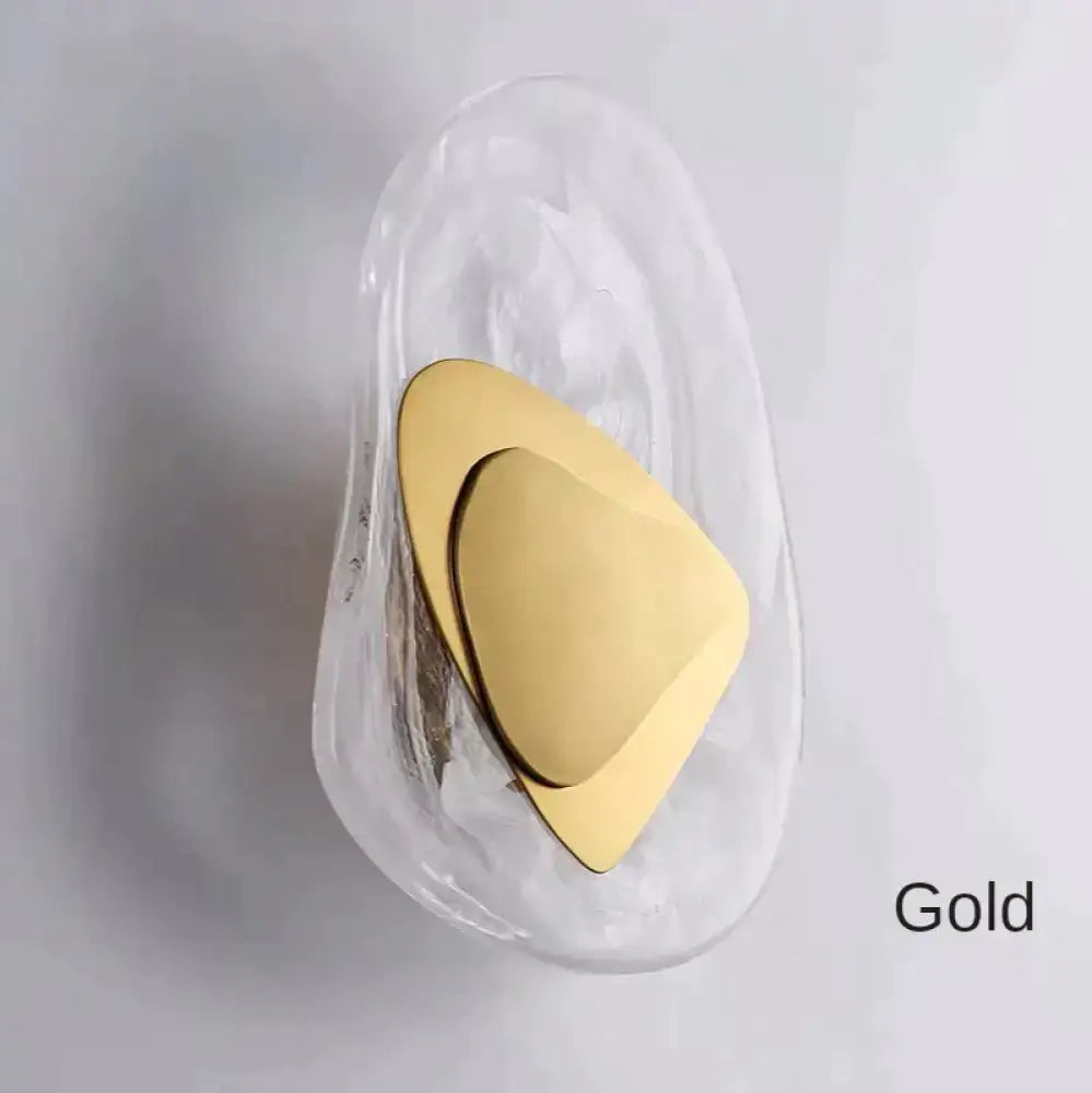 Modern creative minimalist gold triangular glass wall lamp with sleek metallic finish for bedroom bedside lighting