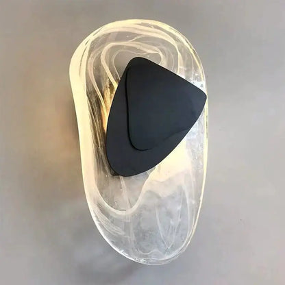 A sleek black triangular minimal glass wall lamp inside a translucent swirling glass container for bedroom lighting