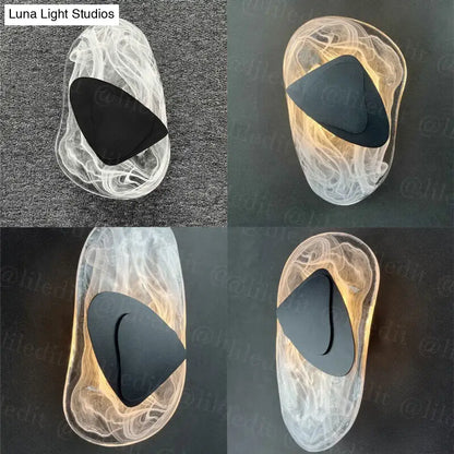 Modern creative minimalist glass wall lamp featuring transparent sculpted sconce with swirling patterns and black accent