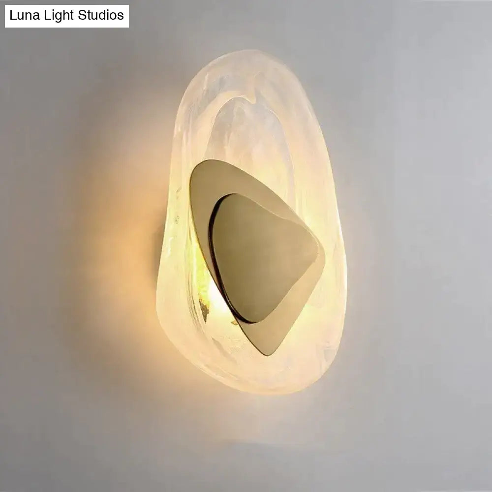 Modern creative minimalist glass wall lamp with frosted translucent shell and polished gold geometric element for bedside lighting