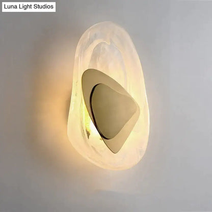 Modern creative minimalist glass wall lamp with frosted translucent shell and polished gold geometric element for bedside lighting