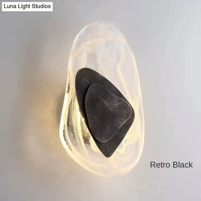 Modern creative minimalist glass wall lamp featuring a retro black sconce with layered hearts in amber resin casing