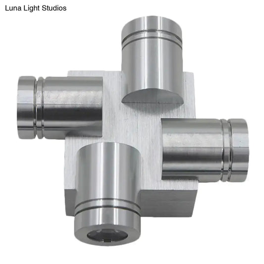 Silver brushed finish cross aluminum wall mount lamp featuring a metallic cross-shaped component with cylindrical ports