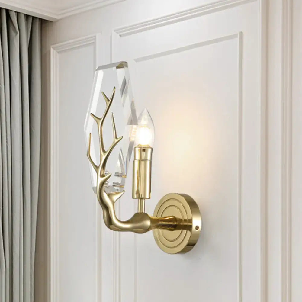 Modern style gold-toned crystal antler sconce light with exposed bulb and direct wired electric wall mount design