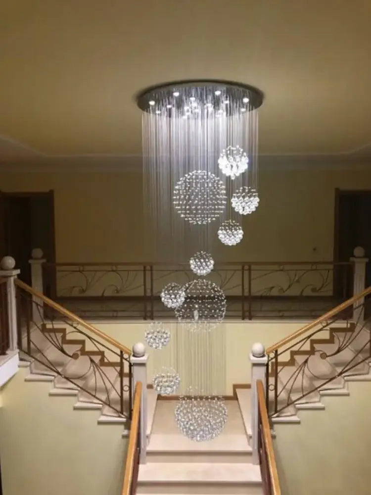A modern crystal ball chandelier with cascading spherical clusters in clear glass for dining room decorbites crystal ball