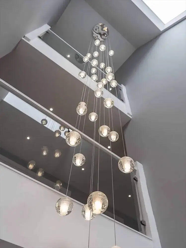 Modern crystal ball led chandelier with cascading clear glass spheres and metallic fixture for living room decor by decorbites