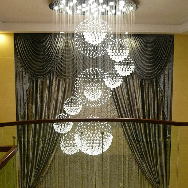 A modern crystal ball led chandelier with clear crystal beads cascading in spherical tiers for living room decorbites decor
