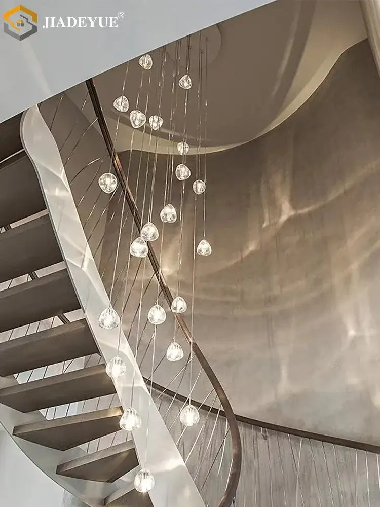 A modern crystal ball nordic led chandelier with multiple spherical lights on a curved metal frame for staircase decor
