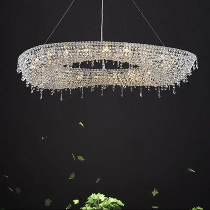 Modern crystal bird nest chandelier featuring multi tiered dangling beads and crystals radiating light in dining room