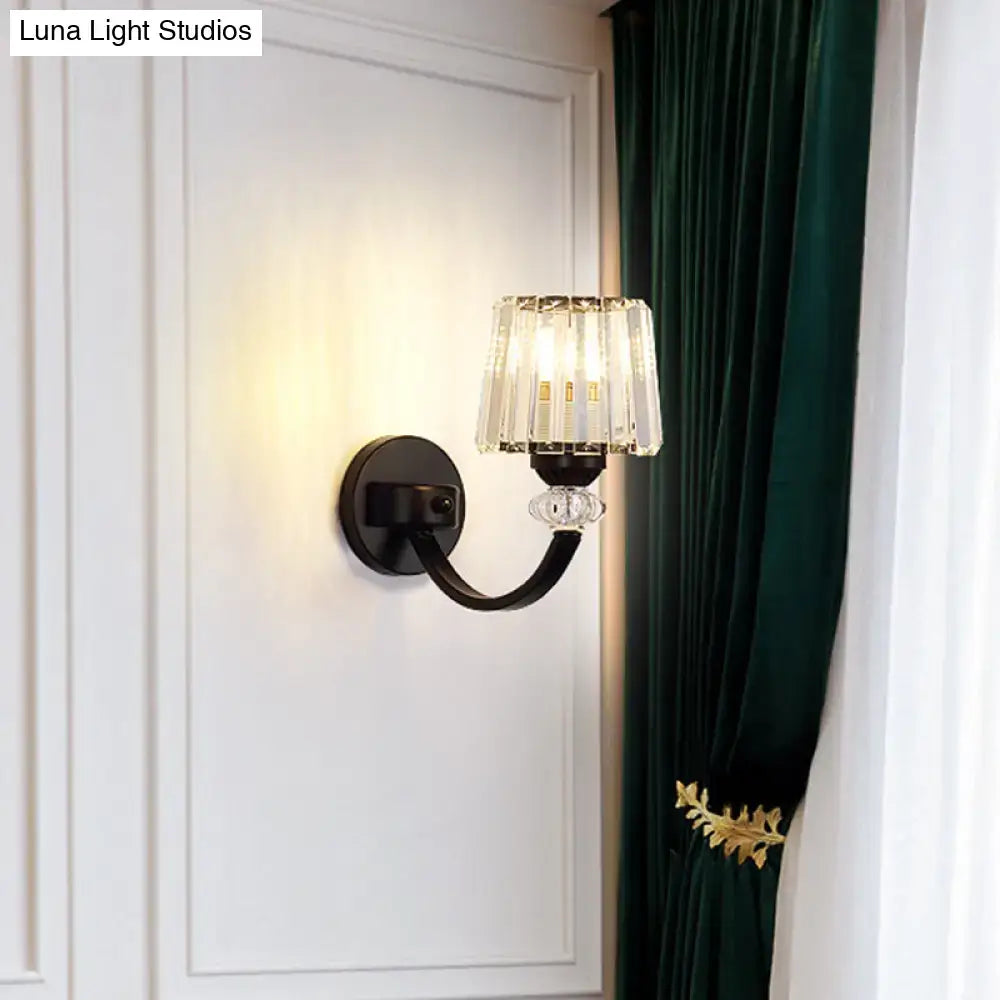 Black gold wall lamp with wrought iron curved arm and crystal chandelier-style shade for bedroom lighting