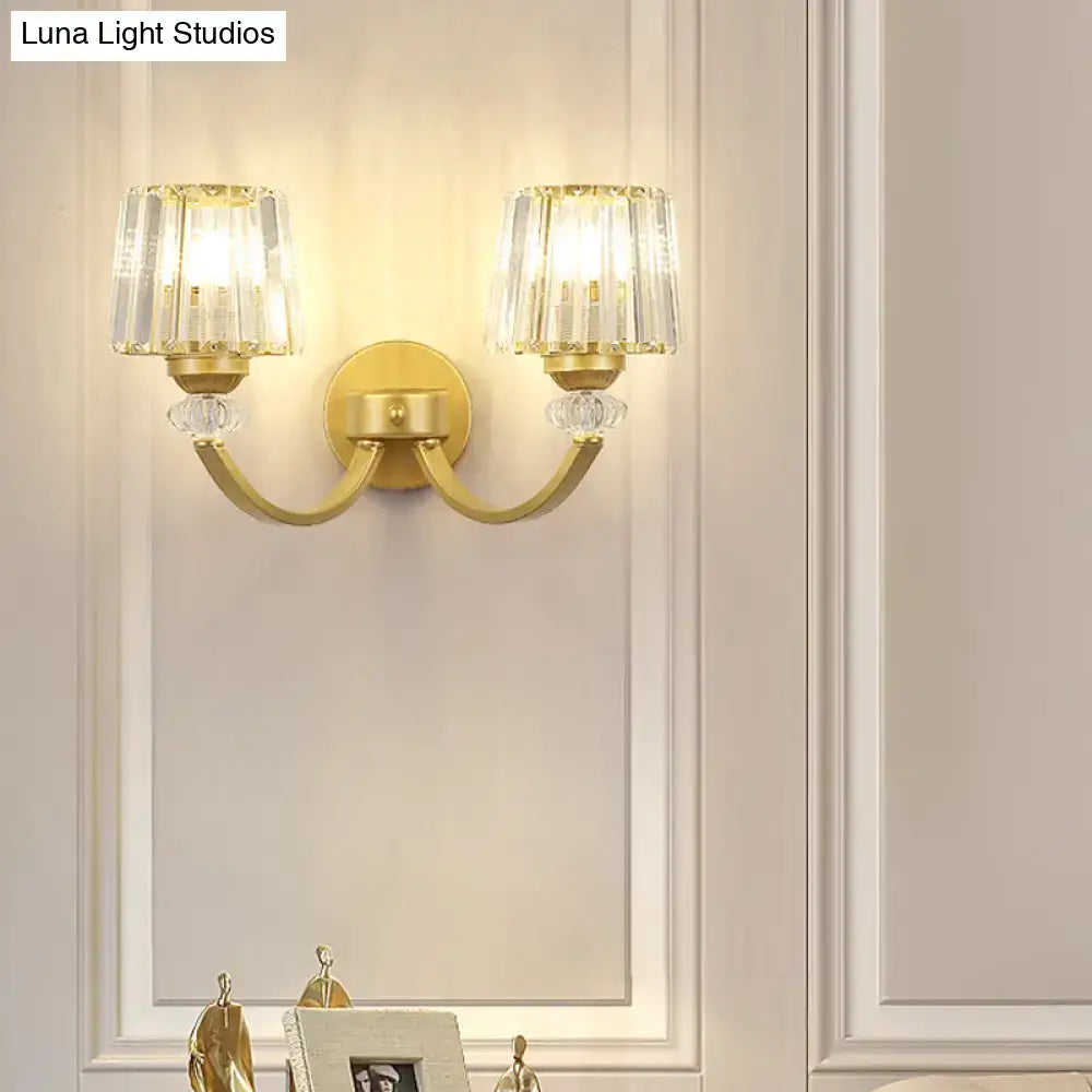 Gold-toned wall lamp with curved arm featuring black gold accents and crystal-encrusted lampshades for bedroom lighting