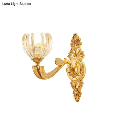 Gold-finished ornate modern crystal block gold wall lamp fixture with clear fluted glass shade for bedroom sconce