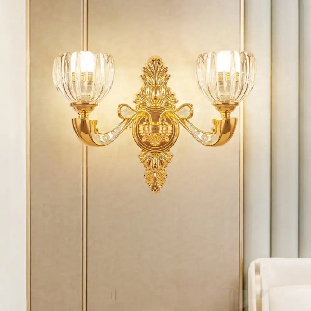 Gold-toned ornate modern crystal block gold wall lamp fixture with two fluted crystal glass shades for bedroom sconce