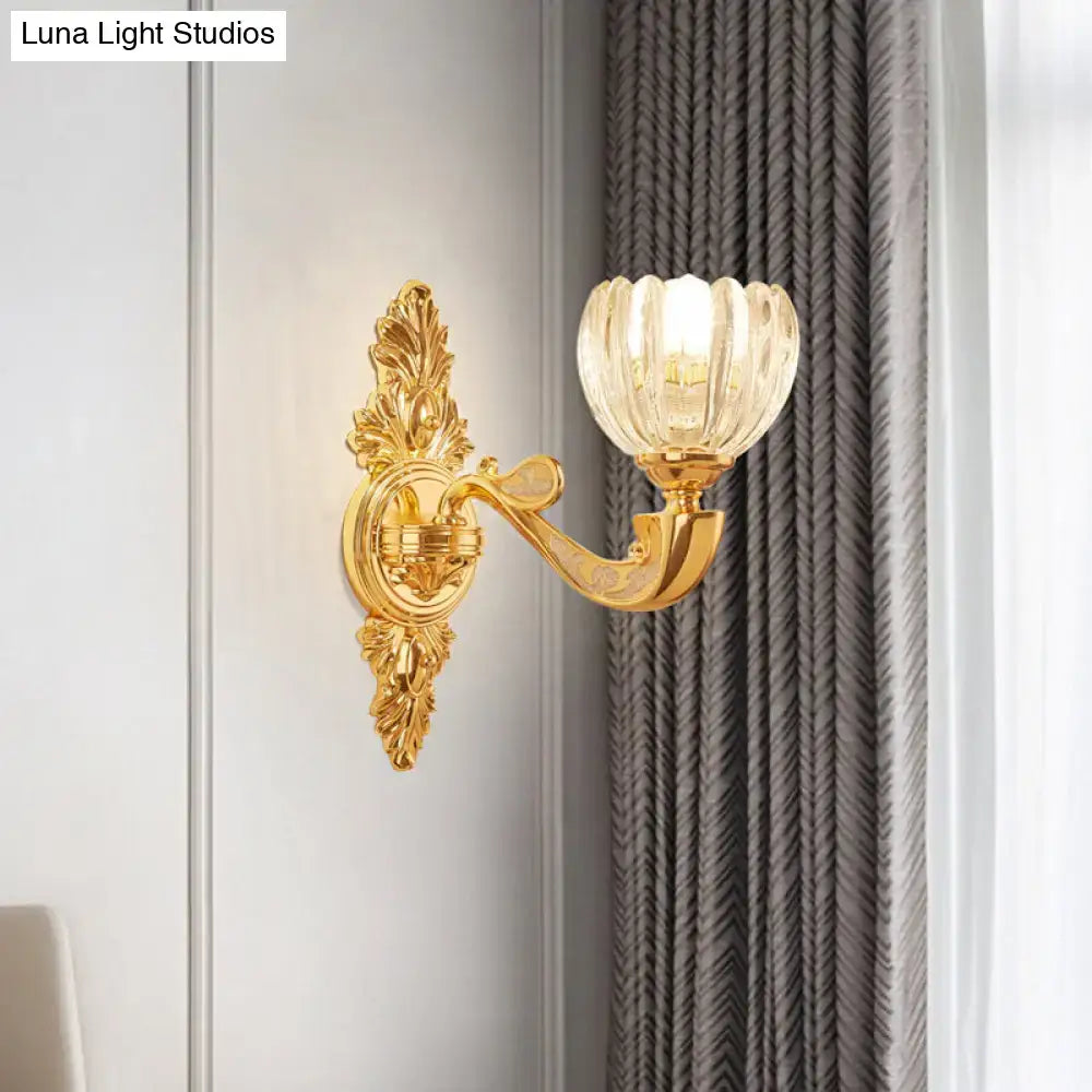 Modern crystal block gold wall lamp fixture featuring a gold-toned ornate sconce with fluted translucent glass shade