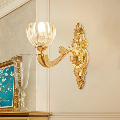 Gold-toned ornate block gold wall lamp fixture with faceted crystal glass shade for modern bedroom sconce lighting