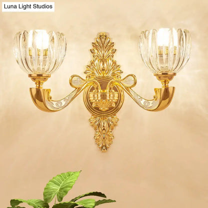Gold-toned crystal block gold wall lamp fixture with two fluted glass shades for modern bedroom sconce lighting