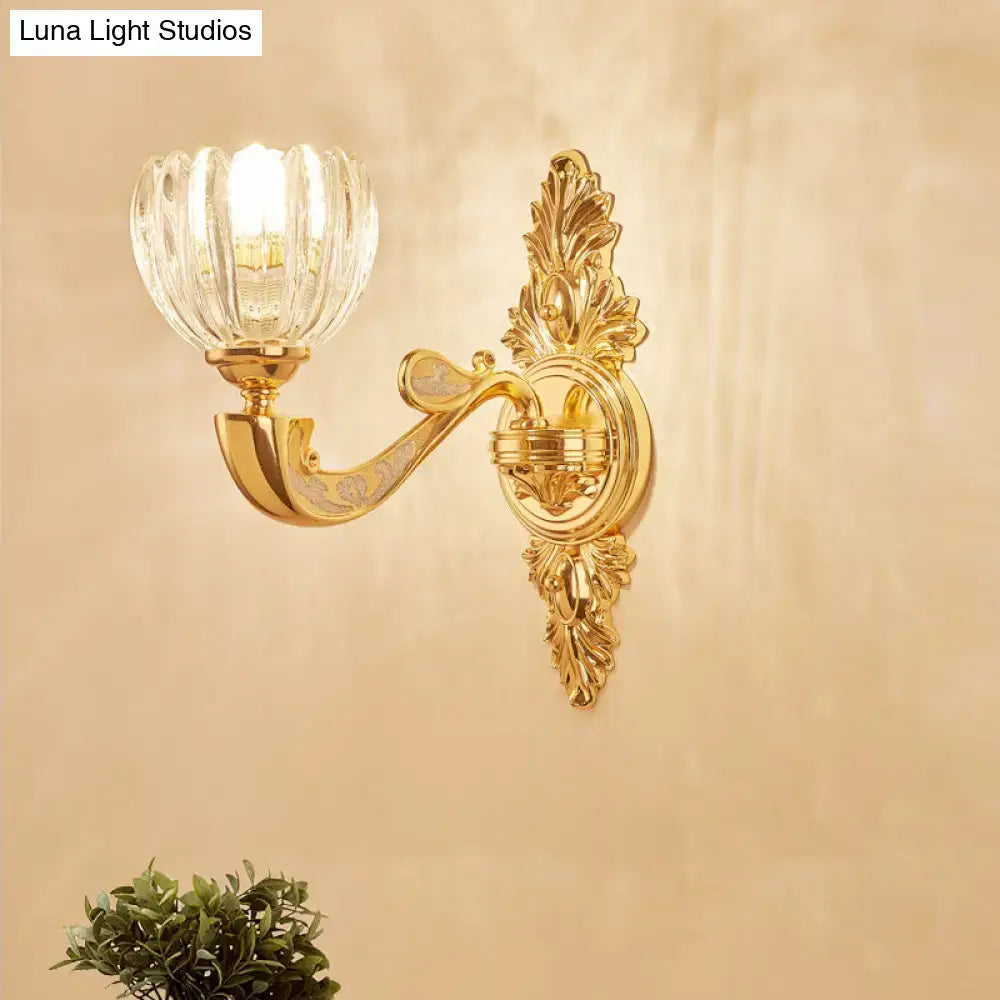 Modern crystal block gold wall lamp fixture with gold-toned ornate design and faceted crystal glass shade bedroom sconce