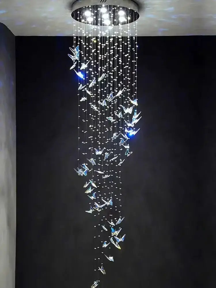 A modern crystal butterfly pendant light with clear crystals pendant strands hanging from a circular ceiling mount