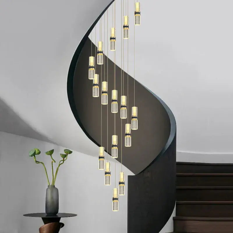 Modern spiral staircase with sleek black metal railings complemented by a crystal columnar chandelier stairwell light