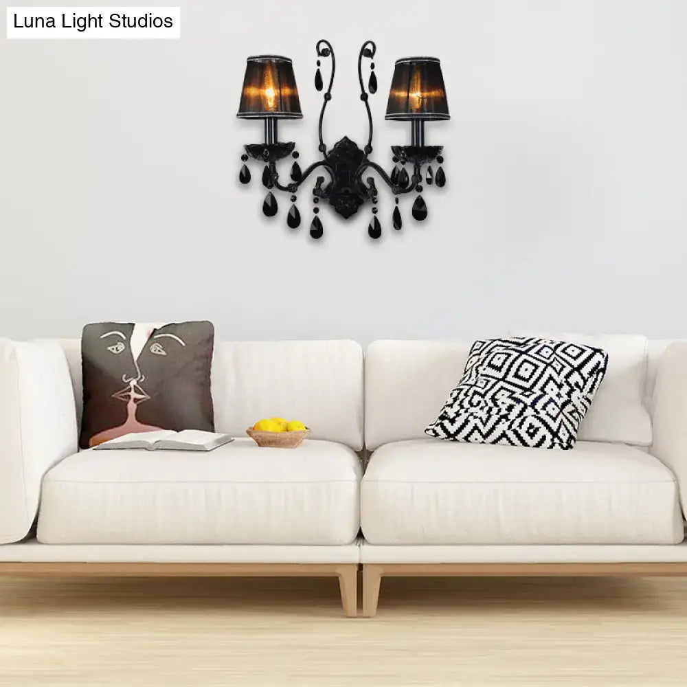 Black wrought iron modern crystal cone wall mount sconce with two lamps and teardrop crystal accents for living room