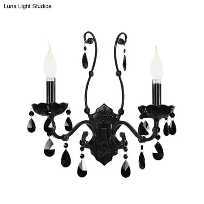 Elegant black wrought iron modern crystal cone wall mount sconce with two candle-style bulbs and teardrop accents