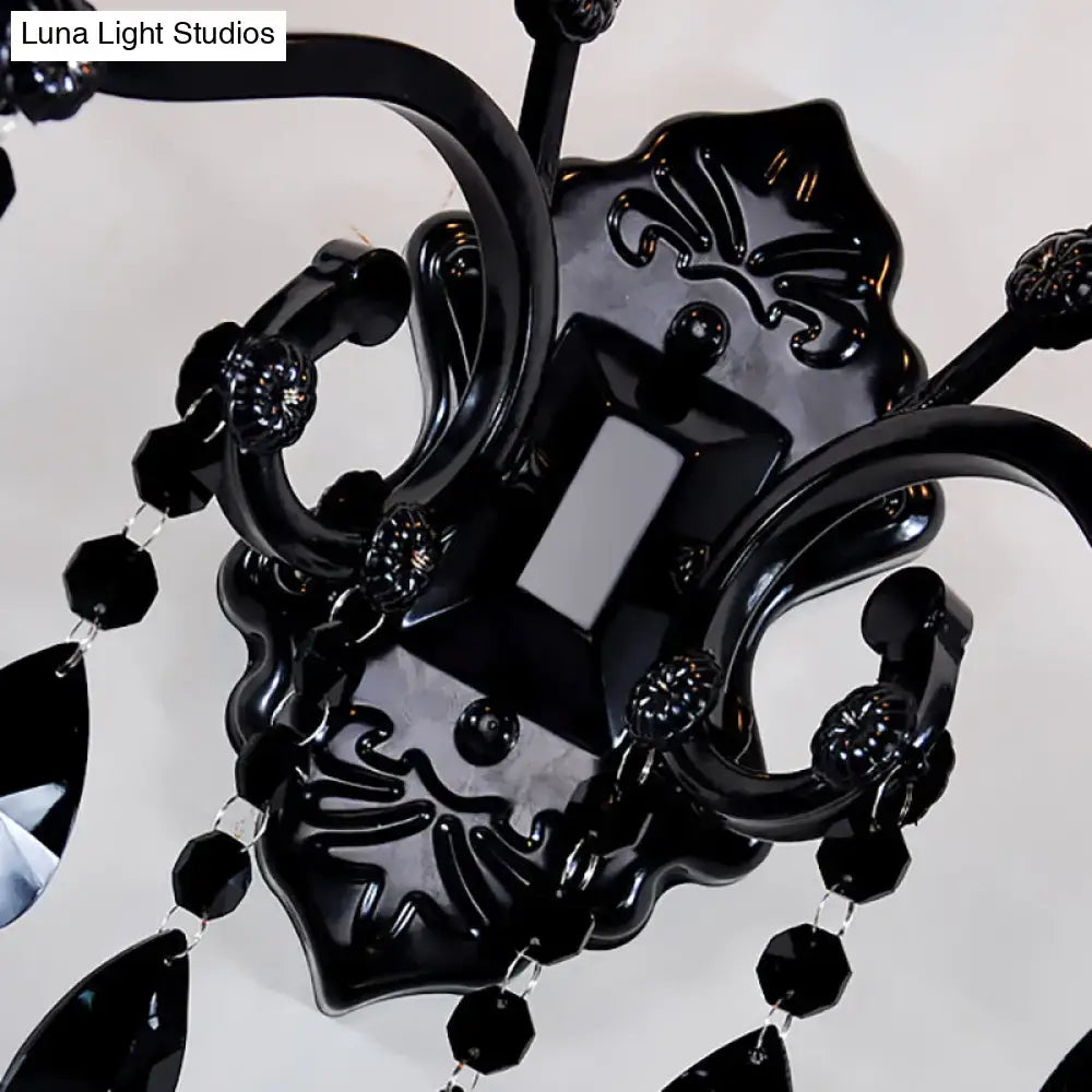 Modern crystal cone wall mount sconce in black featuring a black ornate chandelier with glossy finish and intricate scrollwork