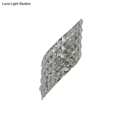Modern crystal diamond wall mounted lamp in silver with faceted crystal squares and curved design for bedroom use