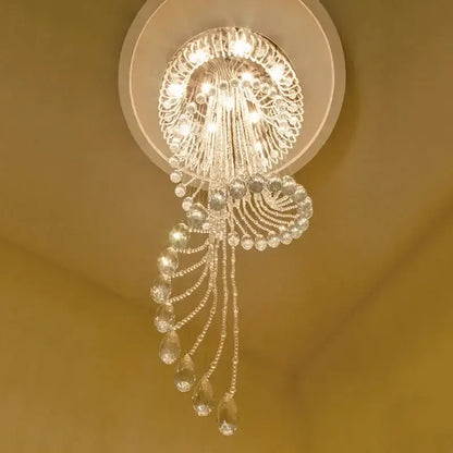 A sparkling crystal modern double spiral staircase chandelier with circular ornate design and teardrop crystals for living room