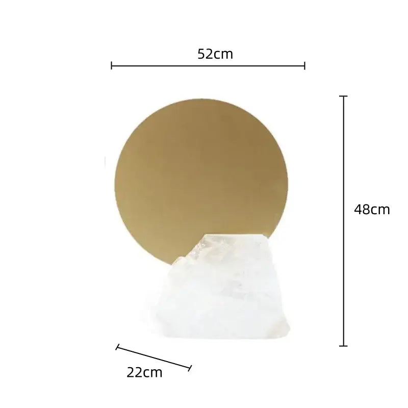 Gold circular wall mirror with white quartz base complementing modern crystal geometric metal sculpture bookends decorbites