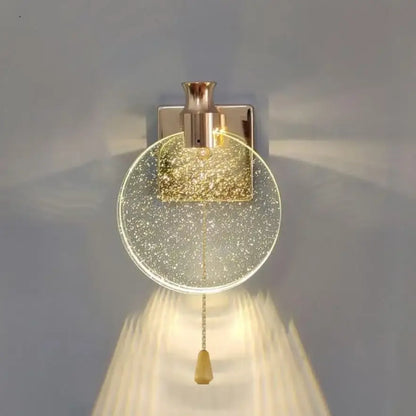 Modern wall lamp with decorbites crystal glass gold circular shade and brushed brass finish for bedroom sconce decor