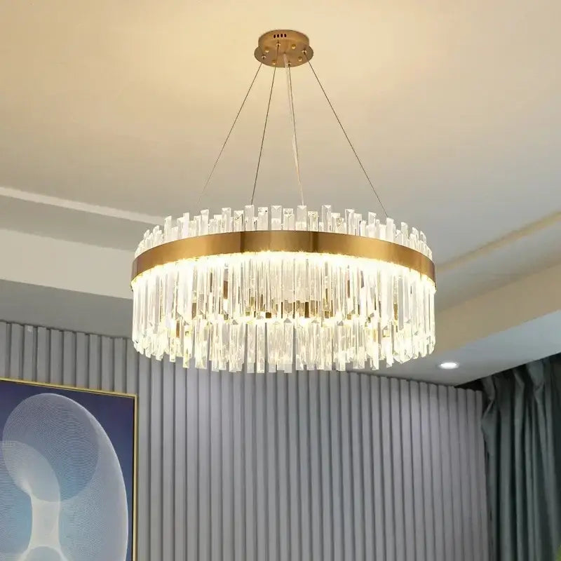 Modern crystal gold ceiling pendant light with gold-toned metal frame and cascading clear crystal rods by decorbites