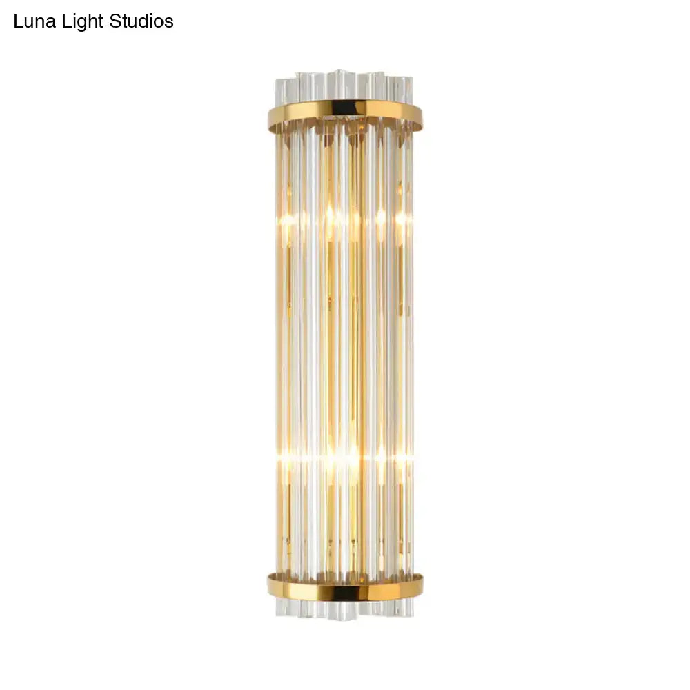 Elegant modern crystal bedroom wall lighting sconce with gold finish metal and clear glass rods in cylindrical design