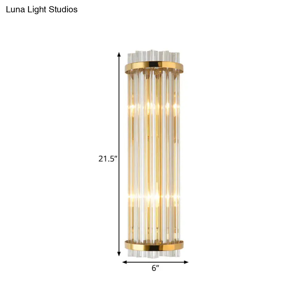 Modern crystal gold finish wall lighting bedroom sconce with gold finish metal frame and vertical glass rods emitting warm light