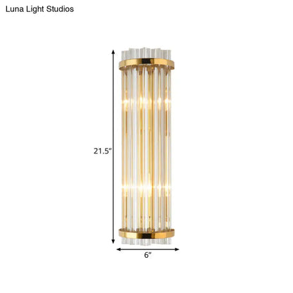 Modern crystal gold finish wall lighting bedroom sconce with gold finish metal frame and vertical glass rods emitting warm light
