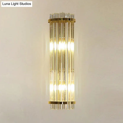 Gold finish modern wall lighting with vertical crystal rods designed as a sleek bedroom sconce in gold finish