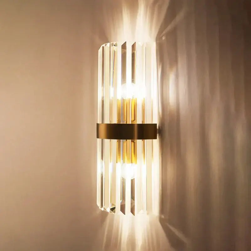 Modern wall sconce with vertical crystal gold led rods and brushed brass band by decorbites for bedroom lighting