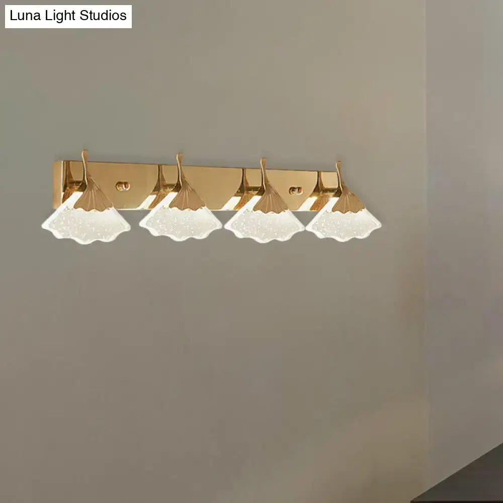 Modern crystal gold vanity light with four frosted leaf-shaped glass shades in a gold finish for bathroom walls